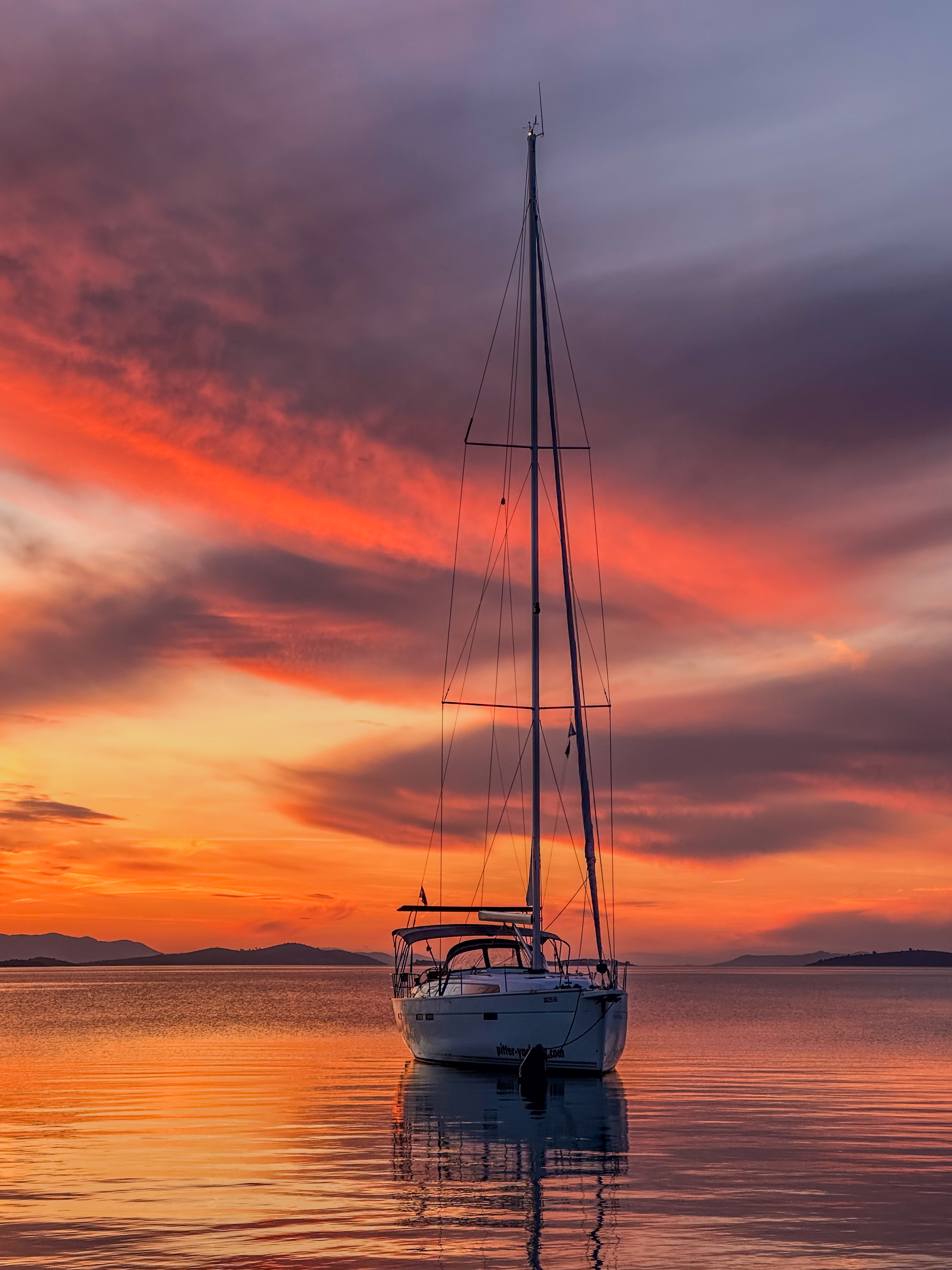 Sailboat in a cove at sunset in the Kornati Islands